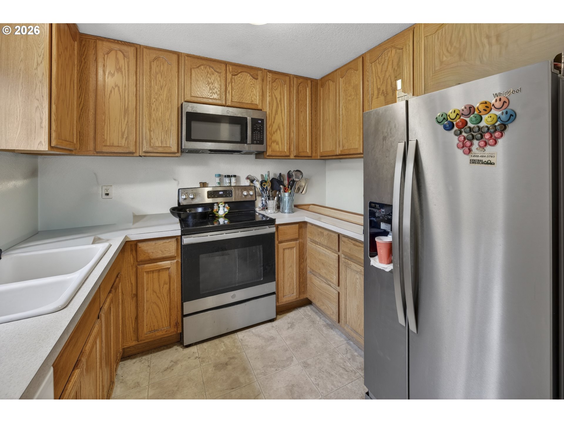 1150 Hemlock Street, Unit B8 Florence, OR 97439 - Photo 8 of 24 a kitchen with a refrigerator sink and microwave