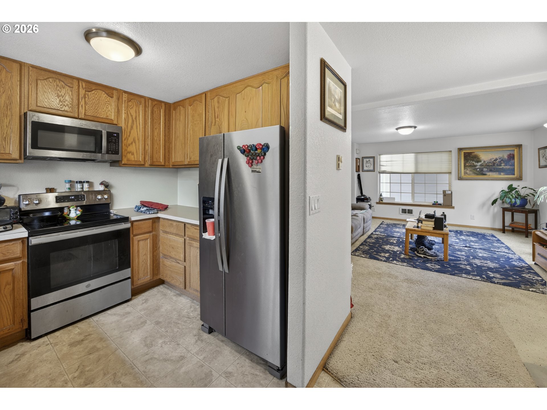 1150 Hemlock Street, Unit B8 Florence, OR 97439 - Photo 10 of 24 a kitchen with stainless steel appliances kitchen island granite countertop a refrigerator and a stove top oven