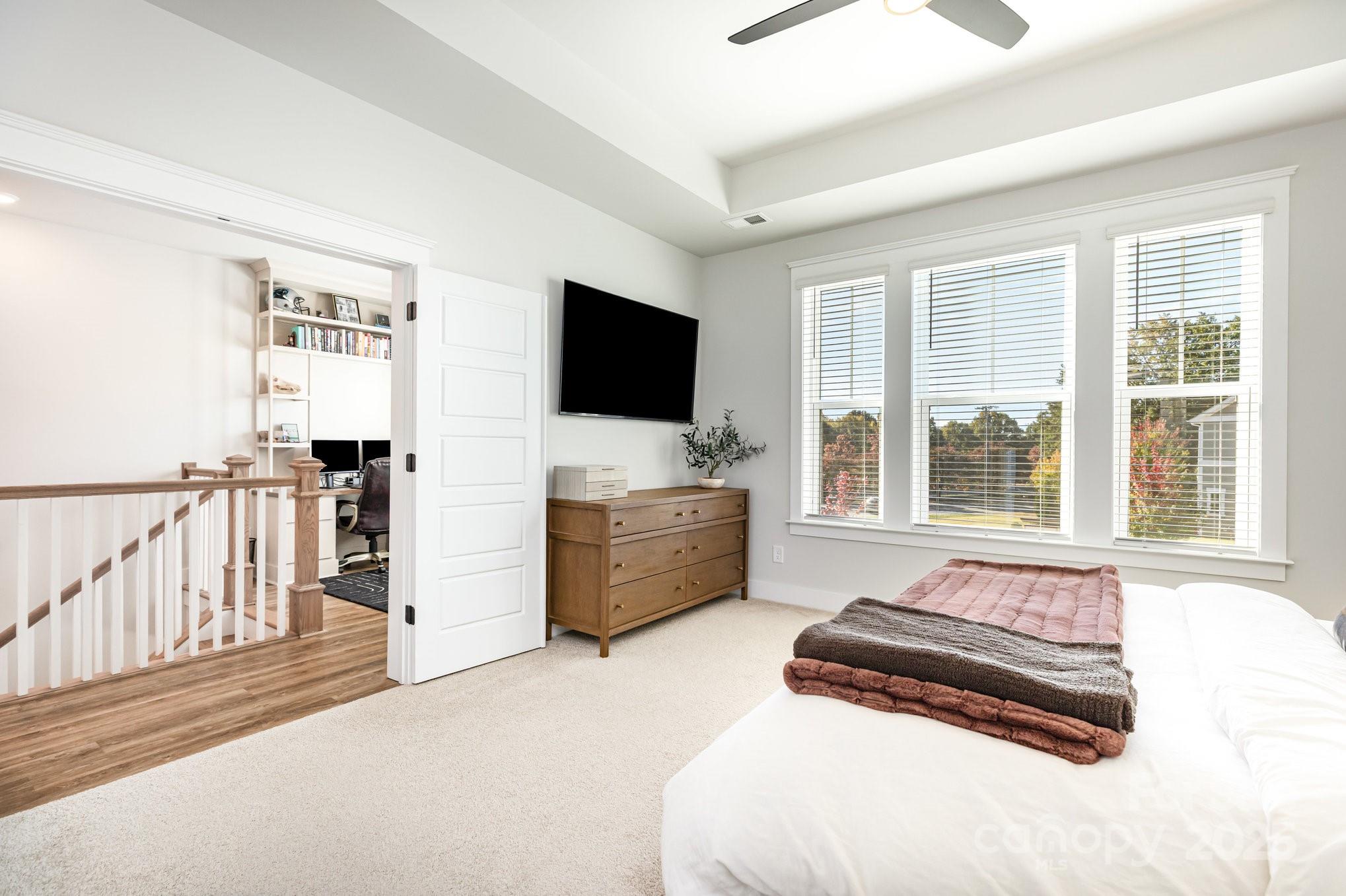 8014 Houser Street Cornelius, NC 28031 - Photo 13 of 24 a bedroom with furniture and flat screen tv