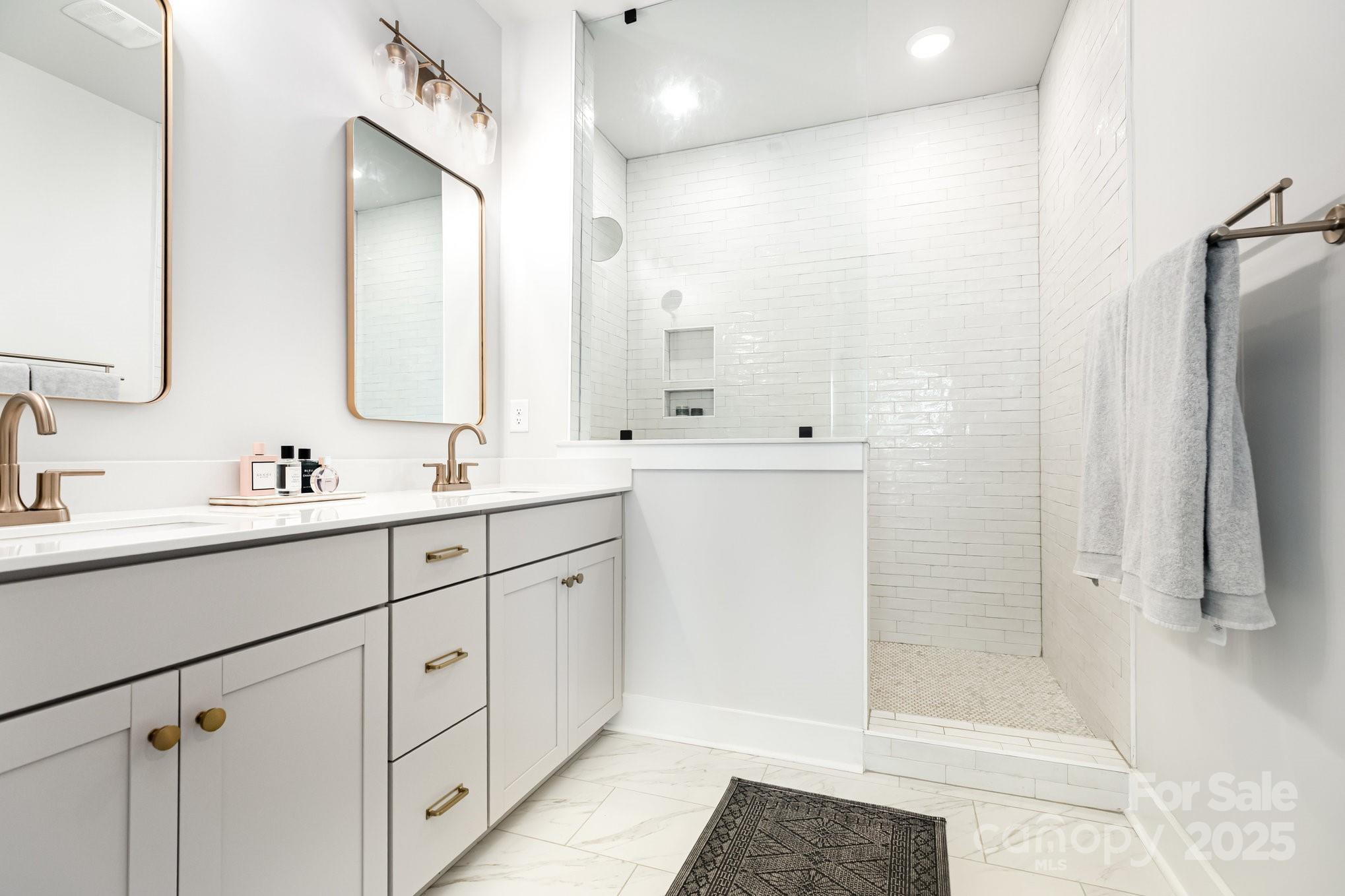 8014 Houser Street Cornelius, NC 28031 - Photo 15 of 24 a bathroom with a double sink shower and a mirror