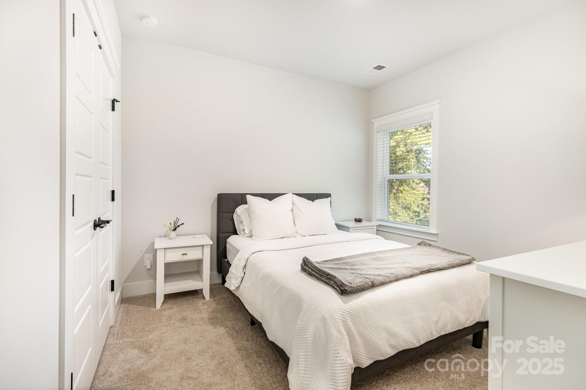 8014 Houser Street Cornelius, NC 28031 - Photo 17 of 24 a bedroom with a bed and a window