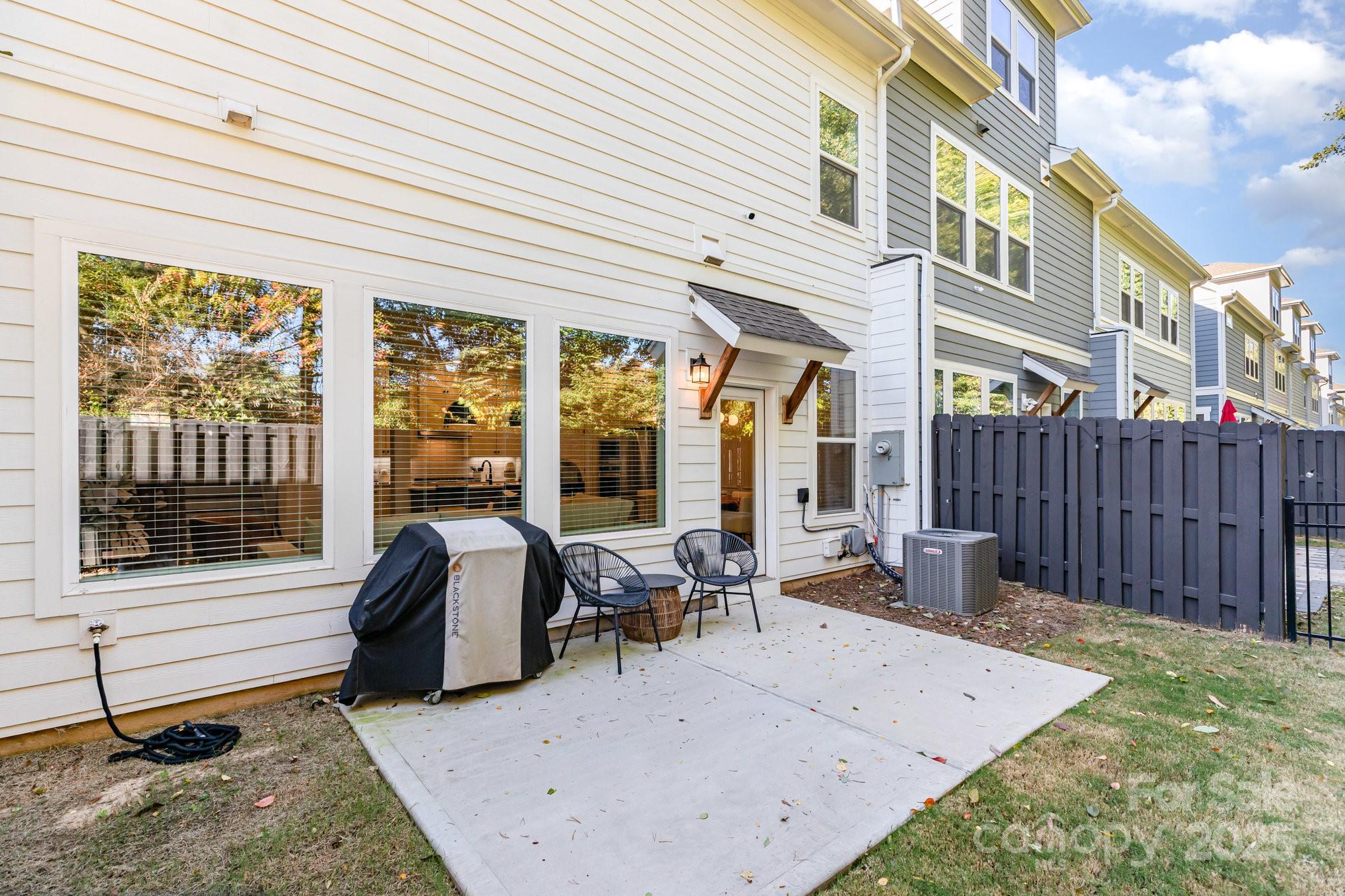 8014 Houser Street Cornelius, NC 28031 - Photo 21 of 24 a view of a patio with a table and chairs and wooden fence