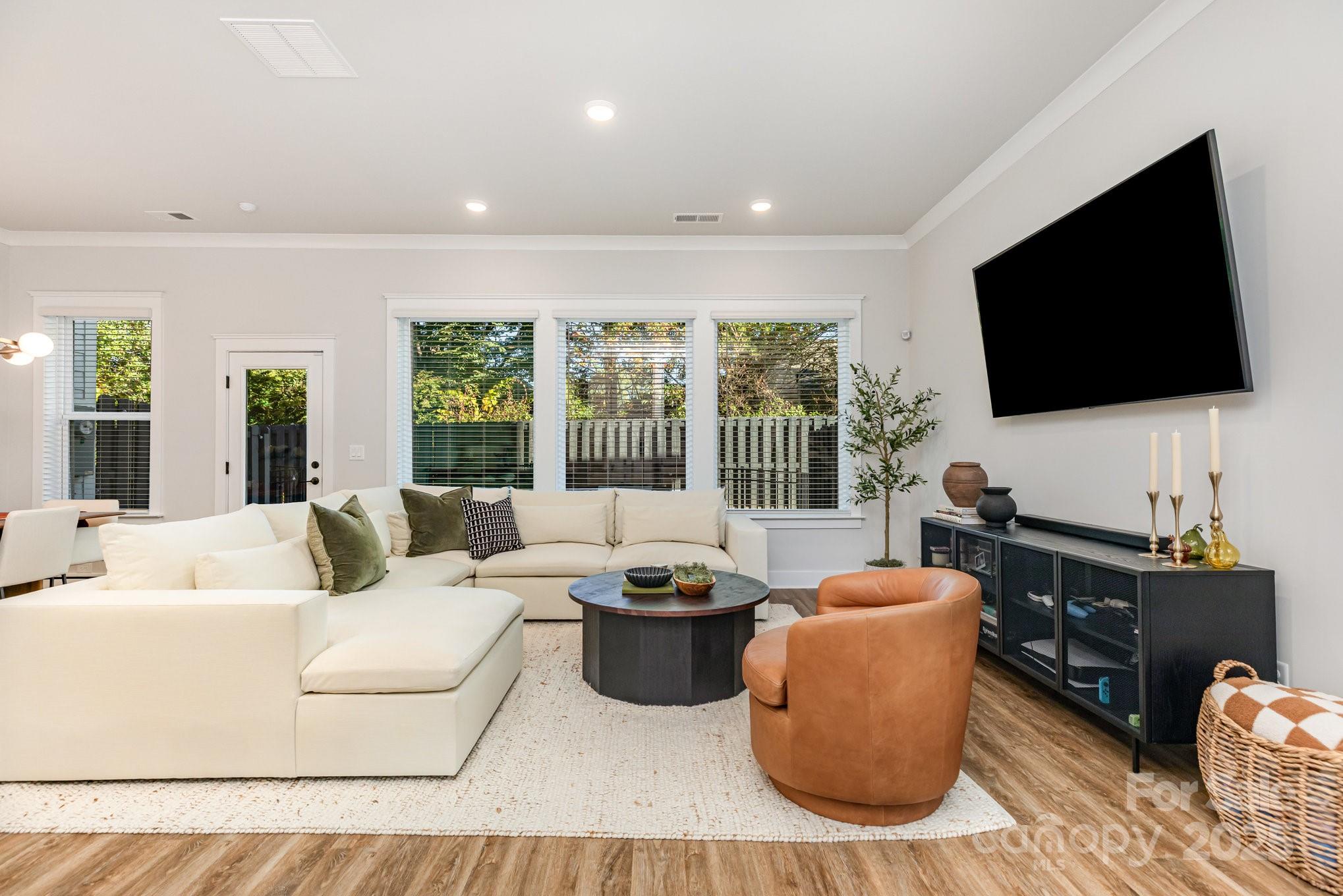 8014 Houser Street Cornelius, NC 28031 - Photo 3 of 24 a living room with furniture and a flat screen tv