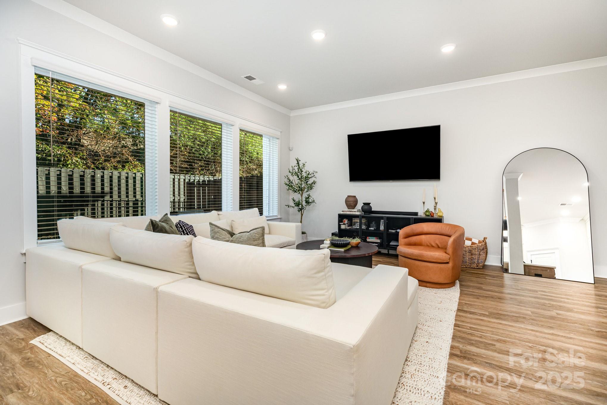 8014 Houser Street Cornelius, NC 28031 - Photo 4 of 24 a living room with furniture and a flat screen tv