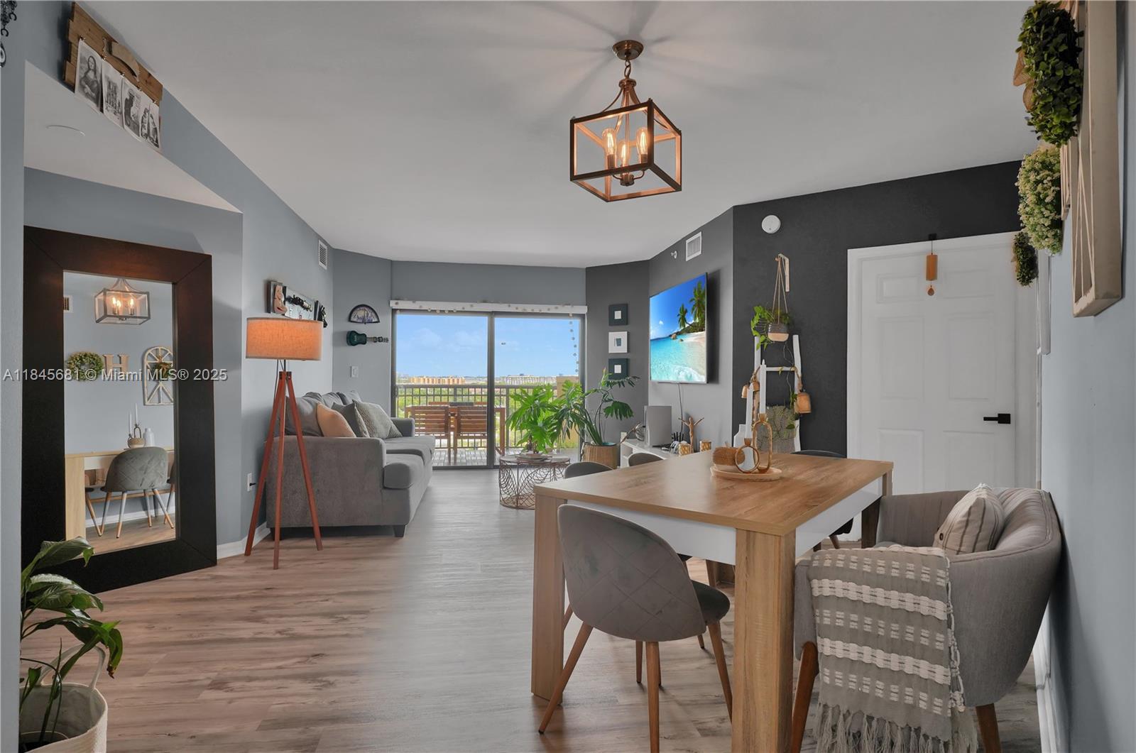 a dining room with furniture a chandelier and wooden floor