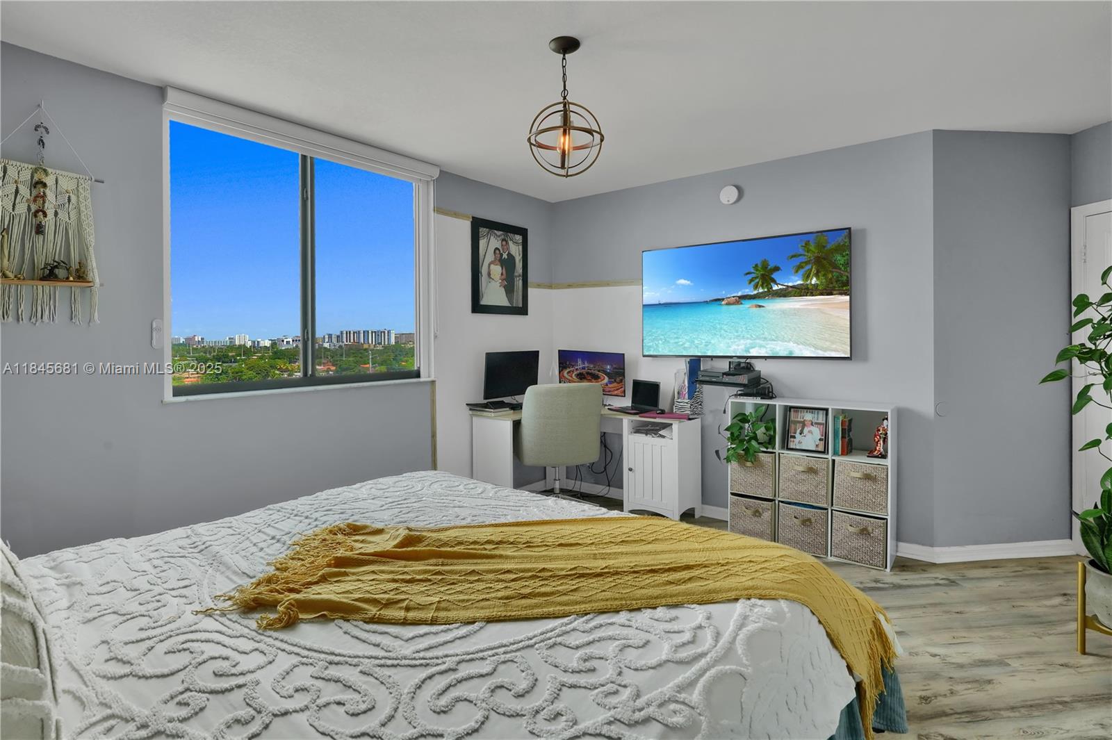 4242 Northwest 2nd Street, Unit 804 Miami, FL 33126 - Photo 11 of 30 a bedroom with a bed and a flat screen tv