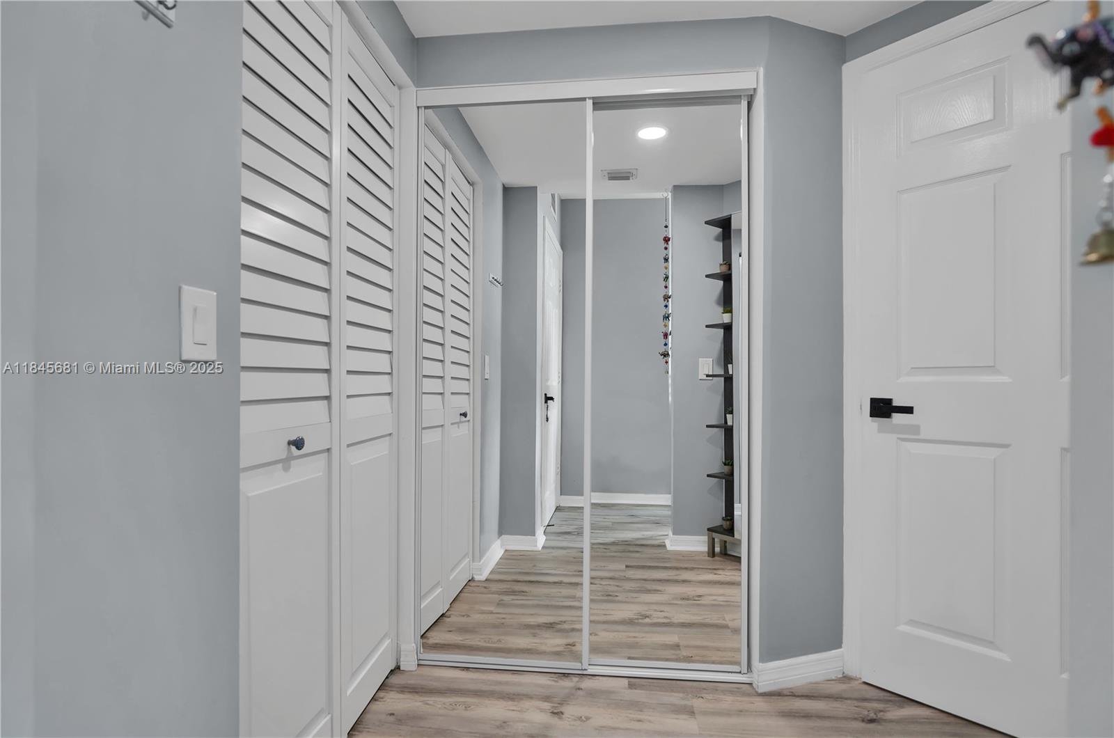 4242 Northwest 2nd Street, Unit 804 Miami, FL 33126 - Photo 13 of 30 a view of a hallway with wooden floor and staircase