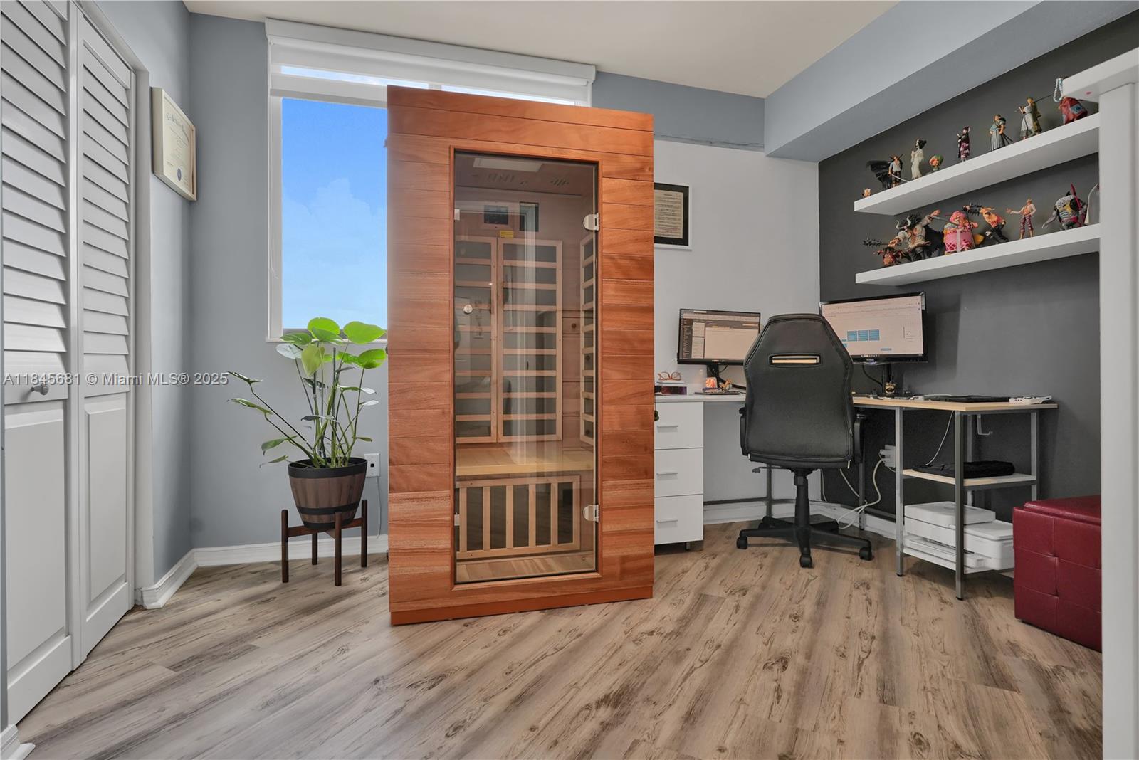 4242 Northwest 2nd Street, Unit 804 Miami, FL 33126 - Photo 16 of 30 a workspace with furniture and wooden floor