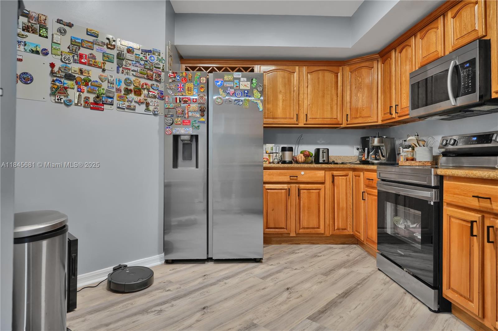 4242 Northwest 2nd Street, Unit 804 Miami, FL 33126 - Photo 3 of 30 a kitchen with stainless steel appliances granite countertop a refrigerator and a sink
