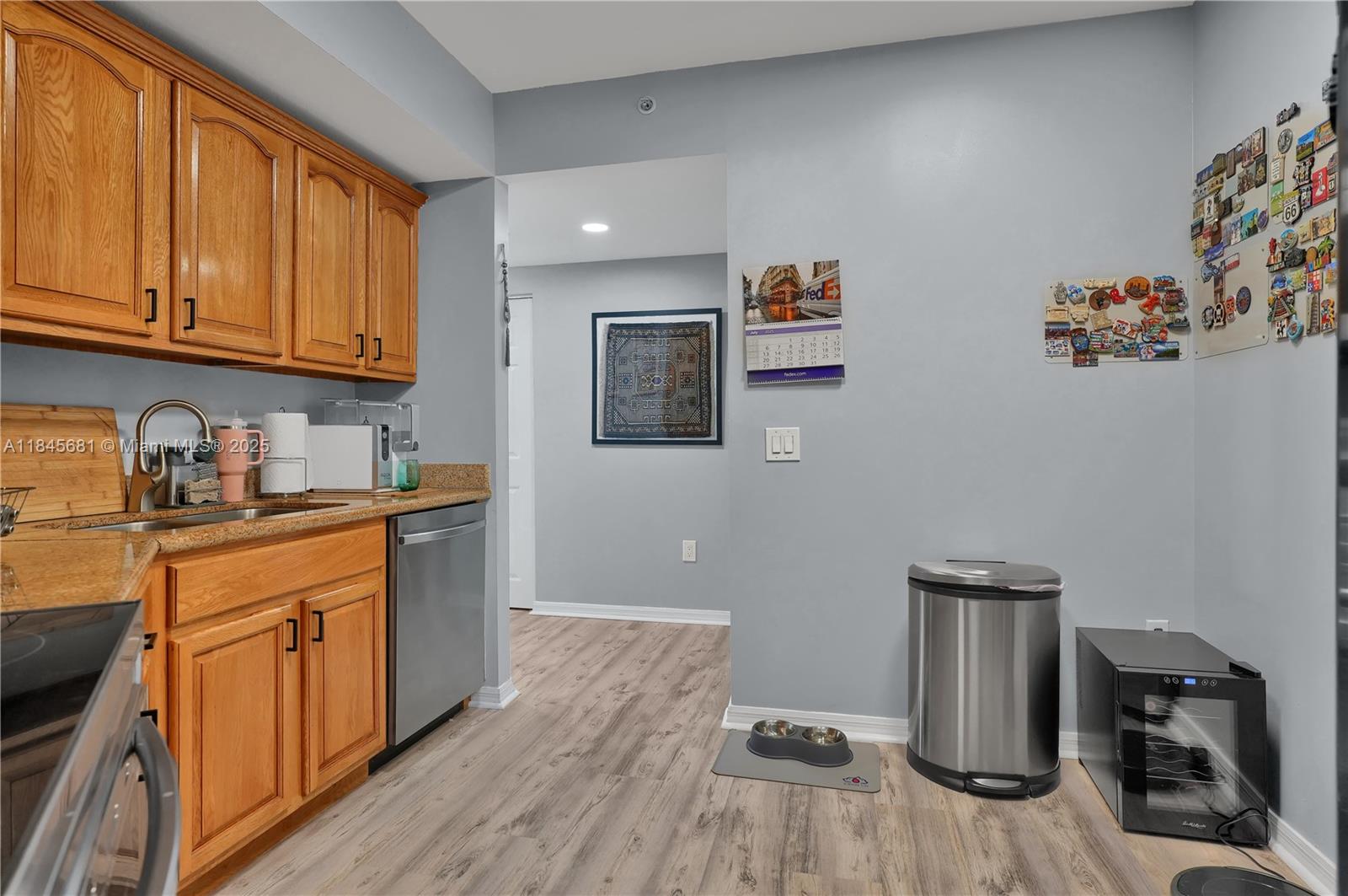 4242 Northwest 2nd Street, Unit 804 Miami, FL 33126 - Photo 4 of 30 a kitchen with a refrigerator and cabinets