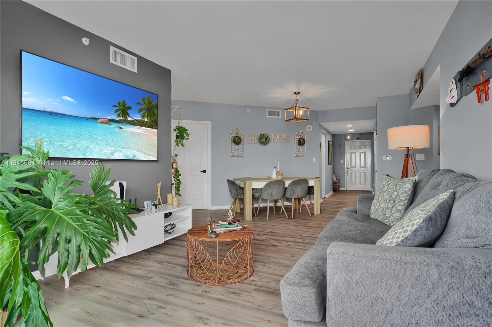 4242 Northwest 2nd Street, Unit 804 Miami, FL 33126 - Photo 5 of 30 a living room with furniture and a potted plant