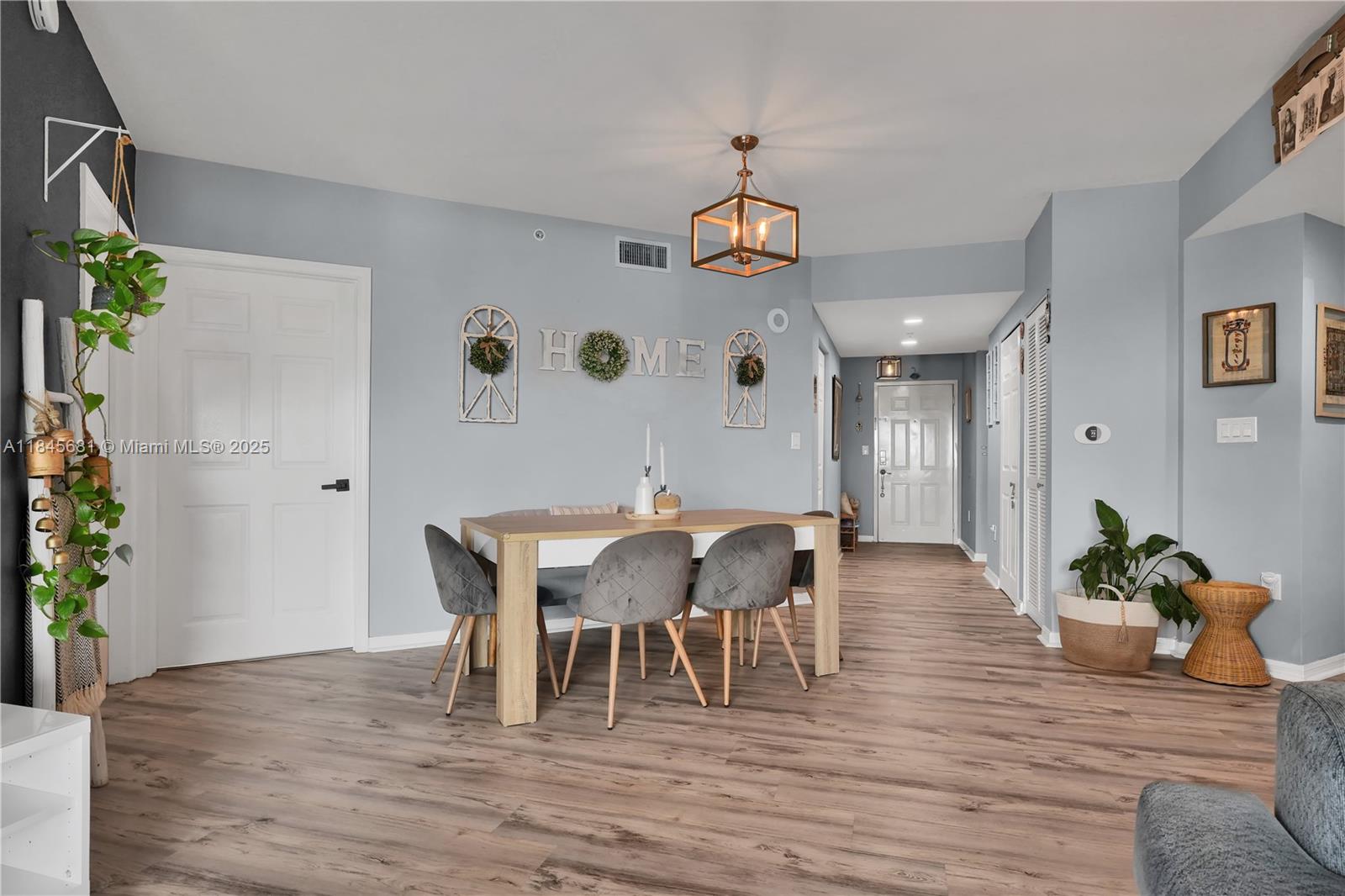 4242 Northwest 2nd Street, Unit 804 Miami, FL 33126 - Photo 8 of 30 a view of a dining room with furniture and wooden floor