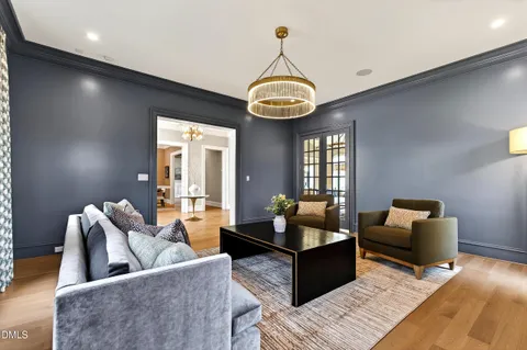a living room with furniture a dining table and a fireplace