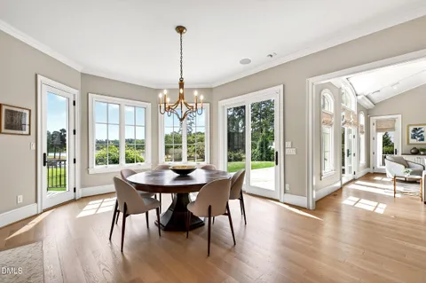 a kitchen with stainless steel appliances cabinets and wooden floor