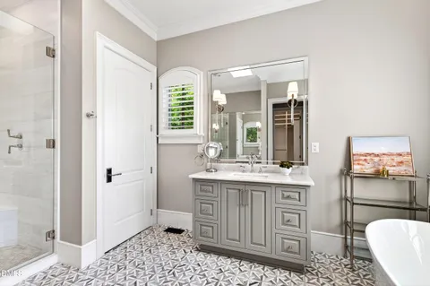 a bathroom with a sink vanity and a mirror