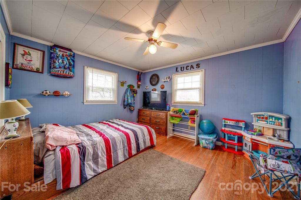 1260 Goodnight Road Salisbury, NC 28147 - Photo 12 of 13 a bedroom with a bed and a chandelier