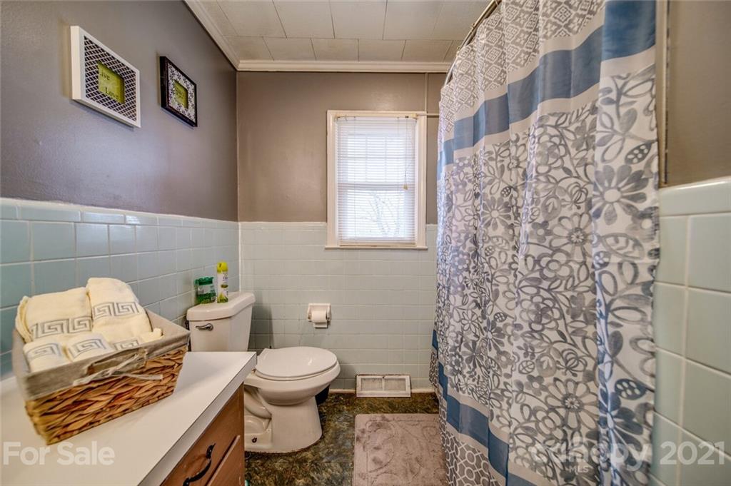 1260 Goodnight Road Salisbury, NC 28147 - Photo 10 of 13 a white toilet sitting next to a bathroom sink