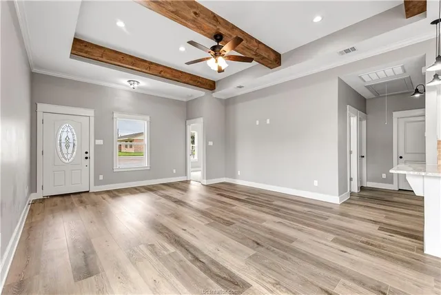 a view of an empty room and wooden floor