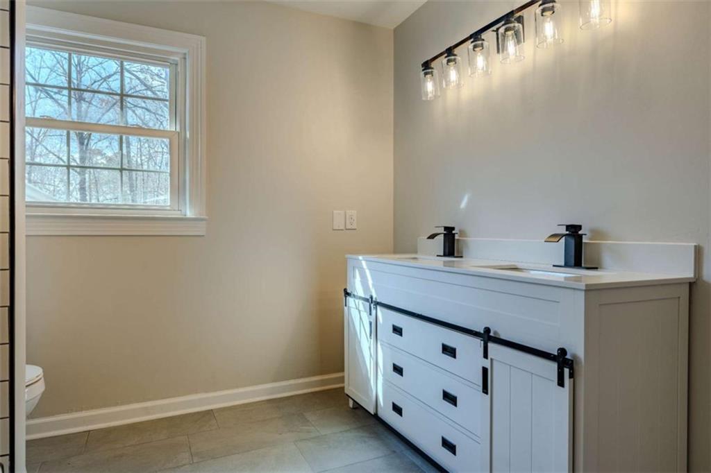 30 Polaris Terrace Northwest Rome, GA 30165 - Photo 29 of 44 a bathroom with a double vanity sink and mirror