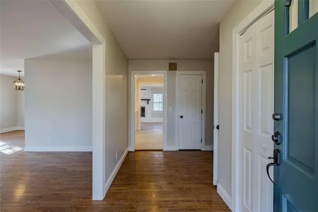 a view of a hallway with wooden floor