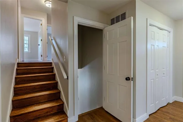 a view of entryway with wooden floor and stairs