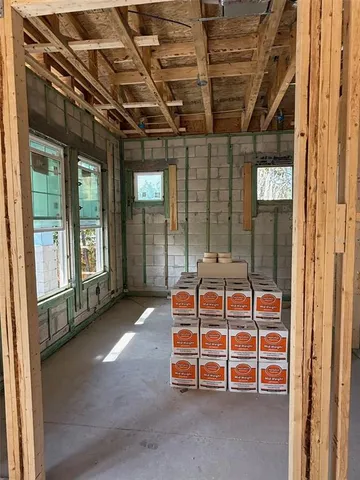 a view of a porch with a table and chairs next to a yard