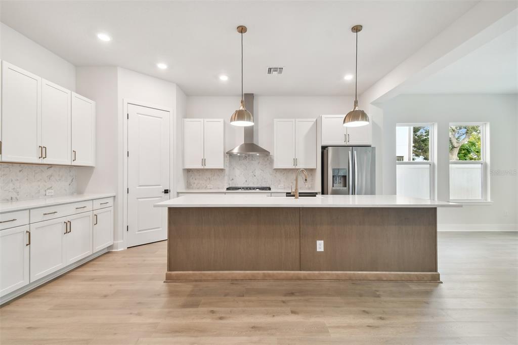 4717 West Laurel Road Tampa, FL 33629 - Photo 15 of 18 a large kitchen with granite countertop a stove a sink a center island and wooden floor
