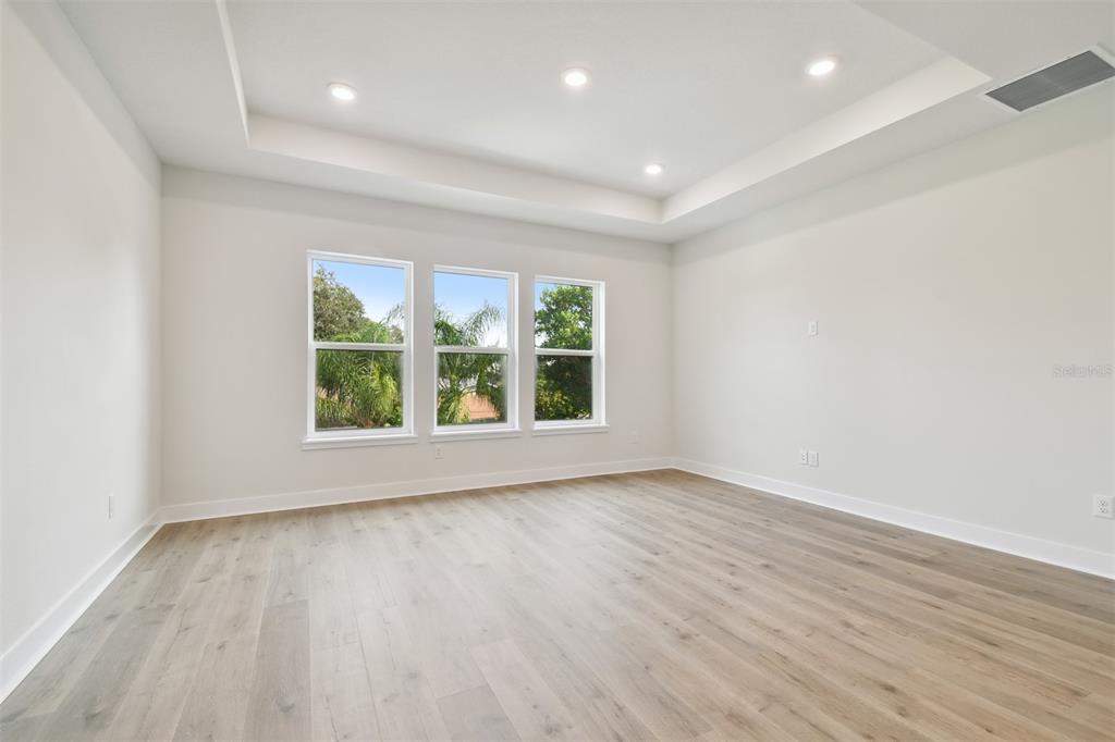 4717 West Laurel Road Tampa, FL 33629 - Photo 18 of 18 an empty room with wooden floor and windows