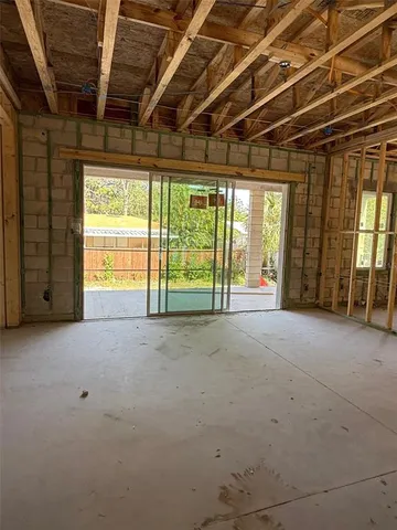 a view of an empty room with glass door