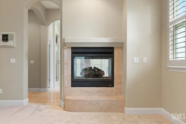 a spacious bathroom with a double vanity sink a toilet and a mirror