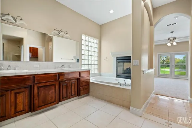 a view of an empty room with a ceiling fan