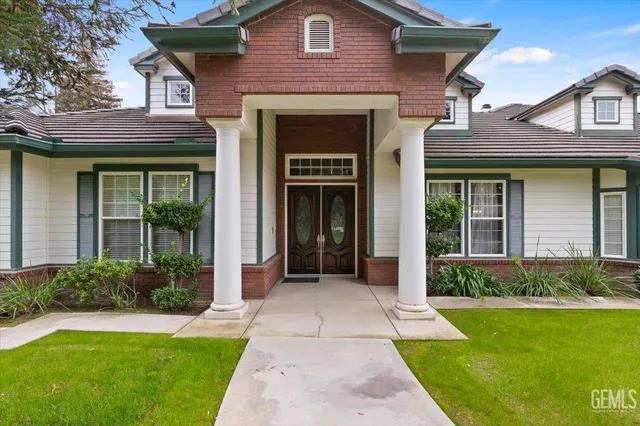 a view of house with yard and green space