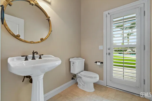 a bathroom with a toilet a sink and shower