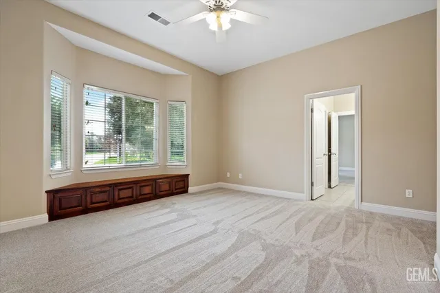 an aerial view of a house with a garden and lake view