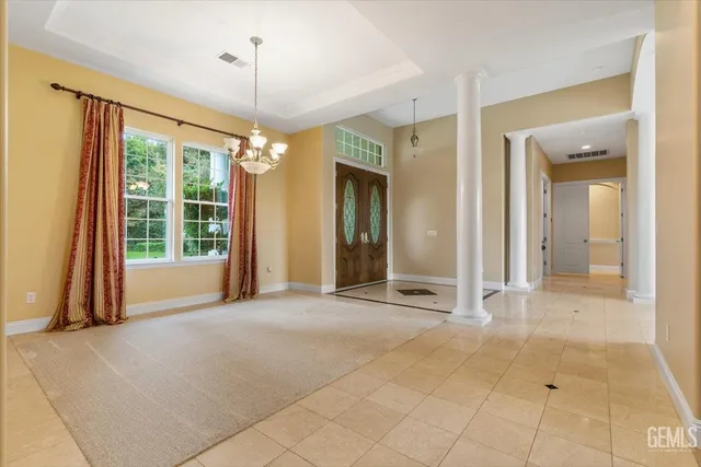 a spacious bathroom with a granite countertop sink and a mirror