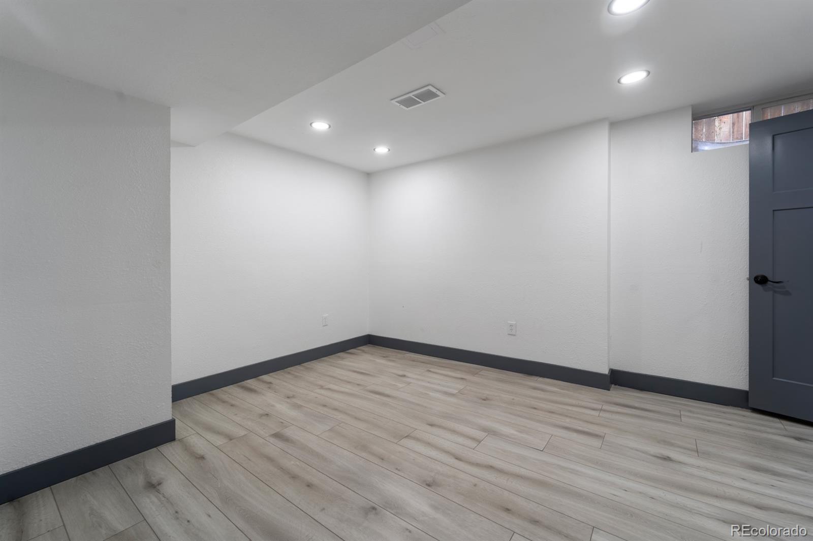 104 Stuart Street Denver, CO 80219 - Photo 15 of 18 a view of empty room with wooden floor