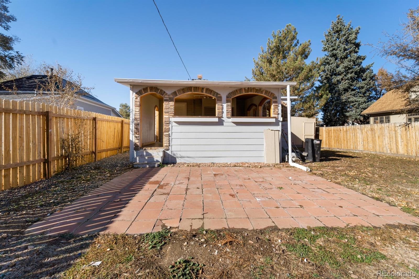 104 Stuart Street Denver, CO 80219 - Photo 17 of 18 a front view of a house with a yard