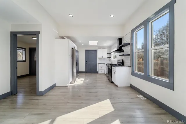 a view of kitchen with furniture and wooden floor
