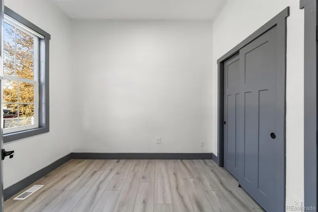 a view of a room with wooden floor and window