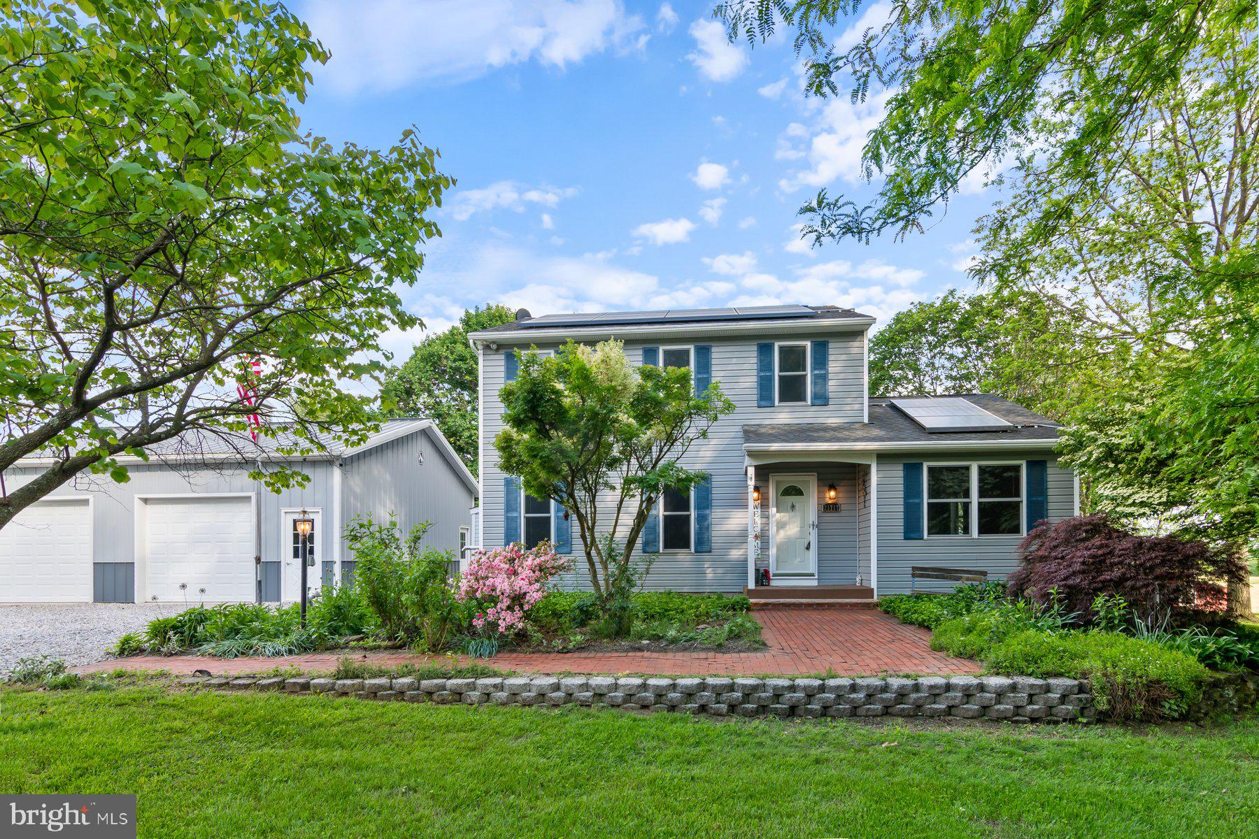 21717 Gunpowder Road Manchester, MD 21102 - Photo 1 of 87 a front view of a house with a garden and yard