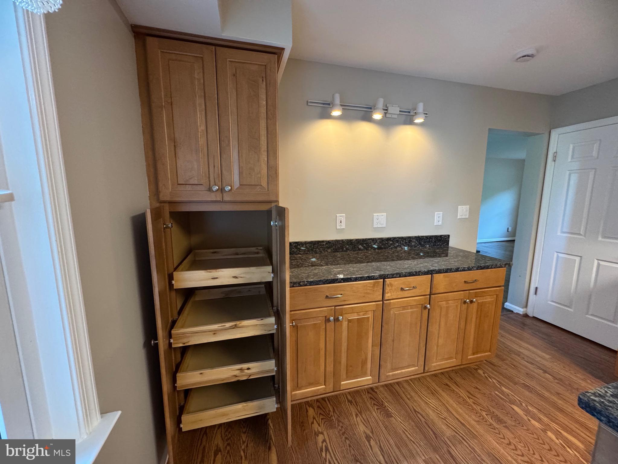 21717 Gunpowder Road Manchester, MD 21102 - Photo 17 of 87 a kitchen with granite countertop wooden cabinets and a stove top oven