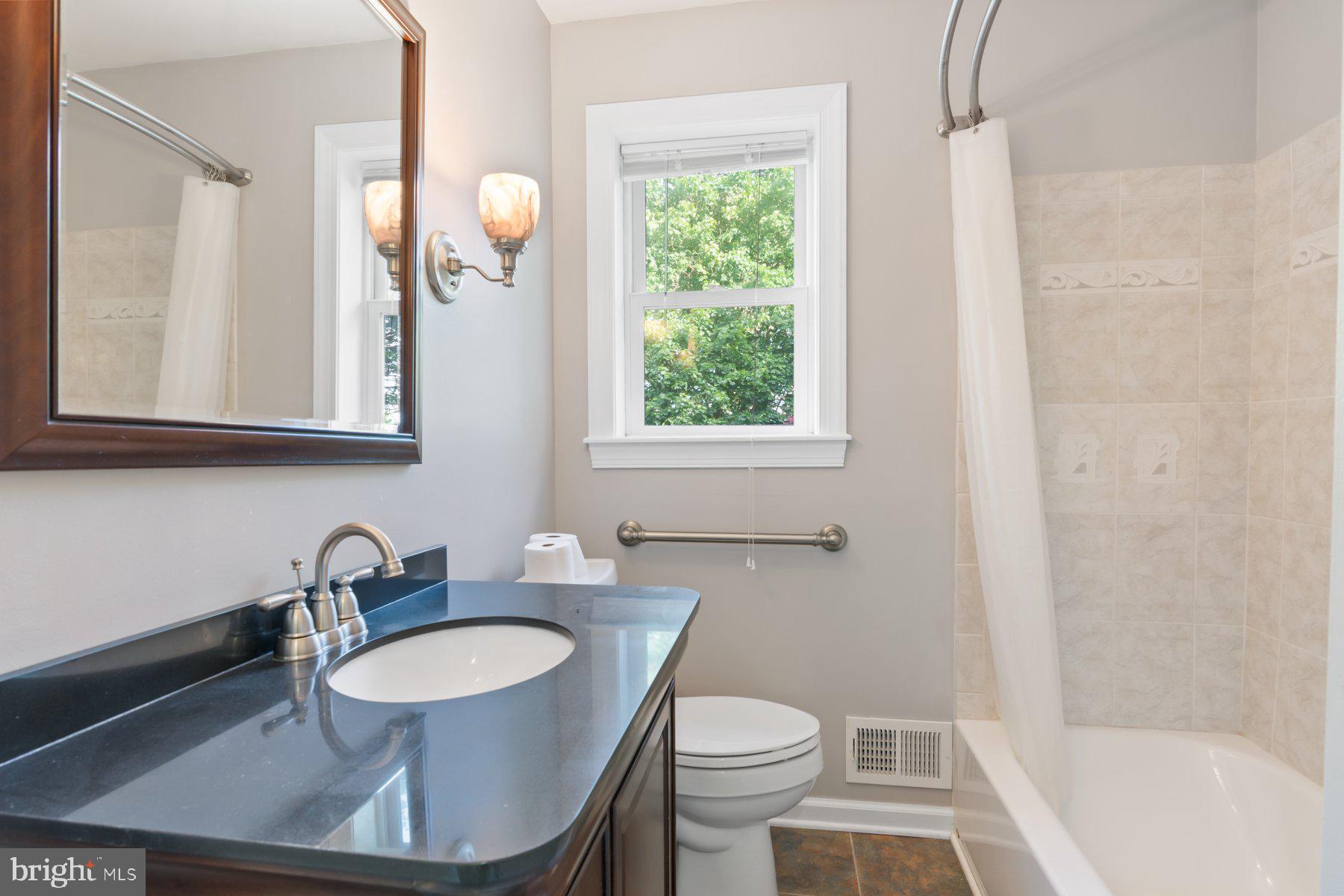 21717 Gunpowder Road Manchester, MD 21102 - Photo 39 of 87 a bathroom with a sink toilet a mirror and a tub