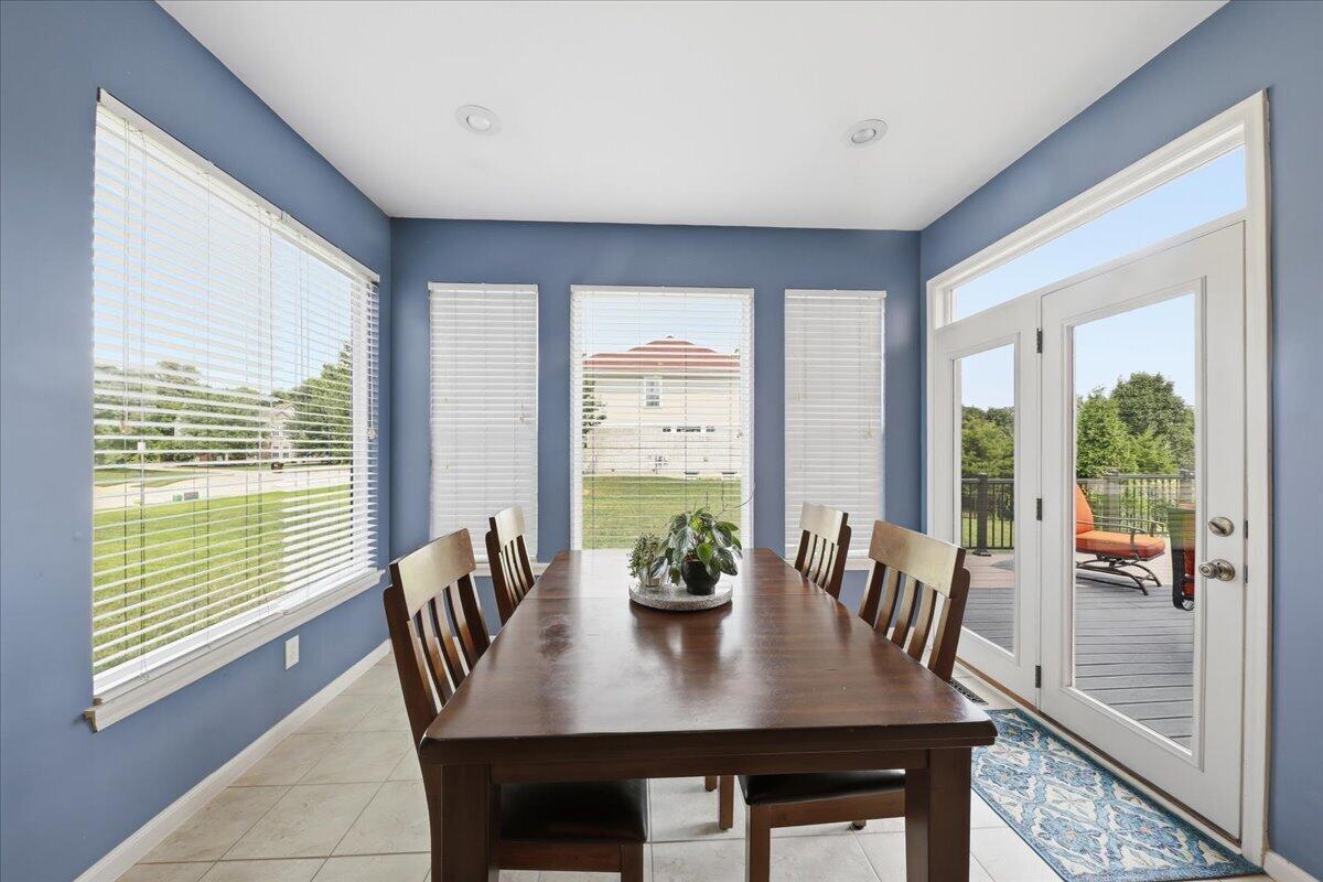 796 Rudolph Way Erlanger, KY 41018 - Photo 13 of 49 796 Rudolph Way, Erlanger KY 41018-Recessed ceiling lighting, tiled flooring, multiple windows with blinds, and white frame double doors leading to an exterior deck