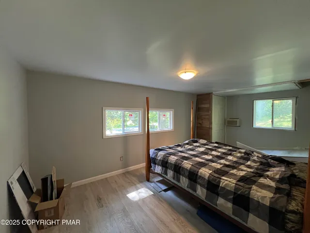 a bedroom with a bed and window