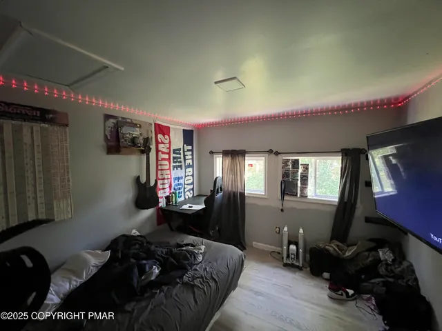 a bedroom with furniture and a window