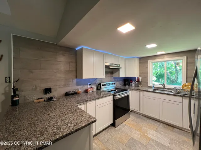 a kitchen with a sink stove and cabinets