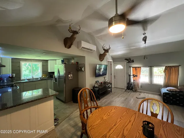 a view of a livingroom with furniture and a kitchen