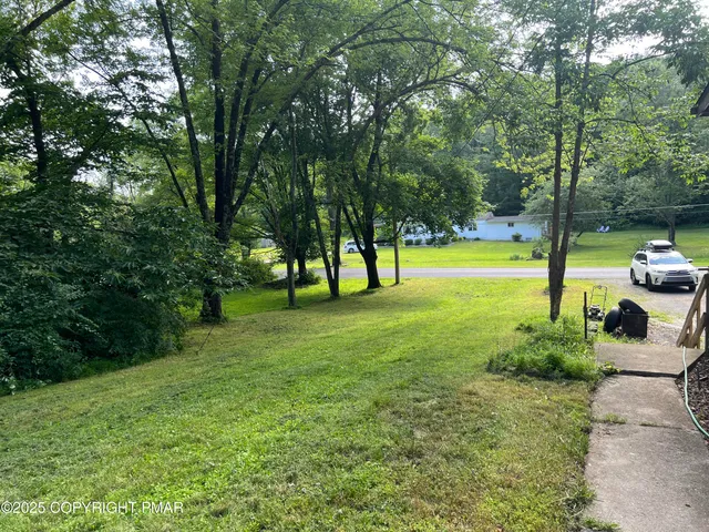 a view of swimming pool with a yard
