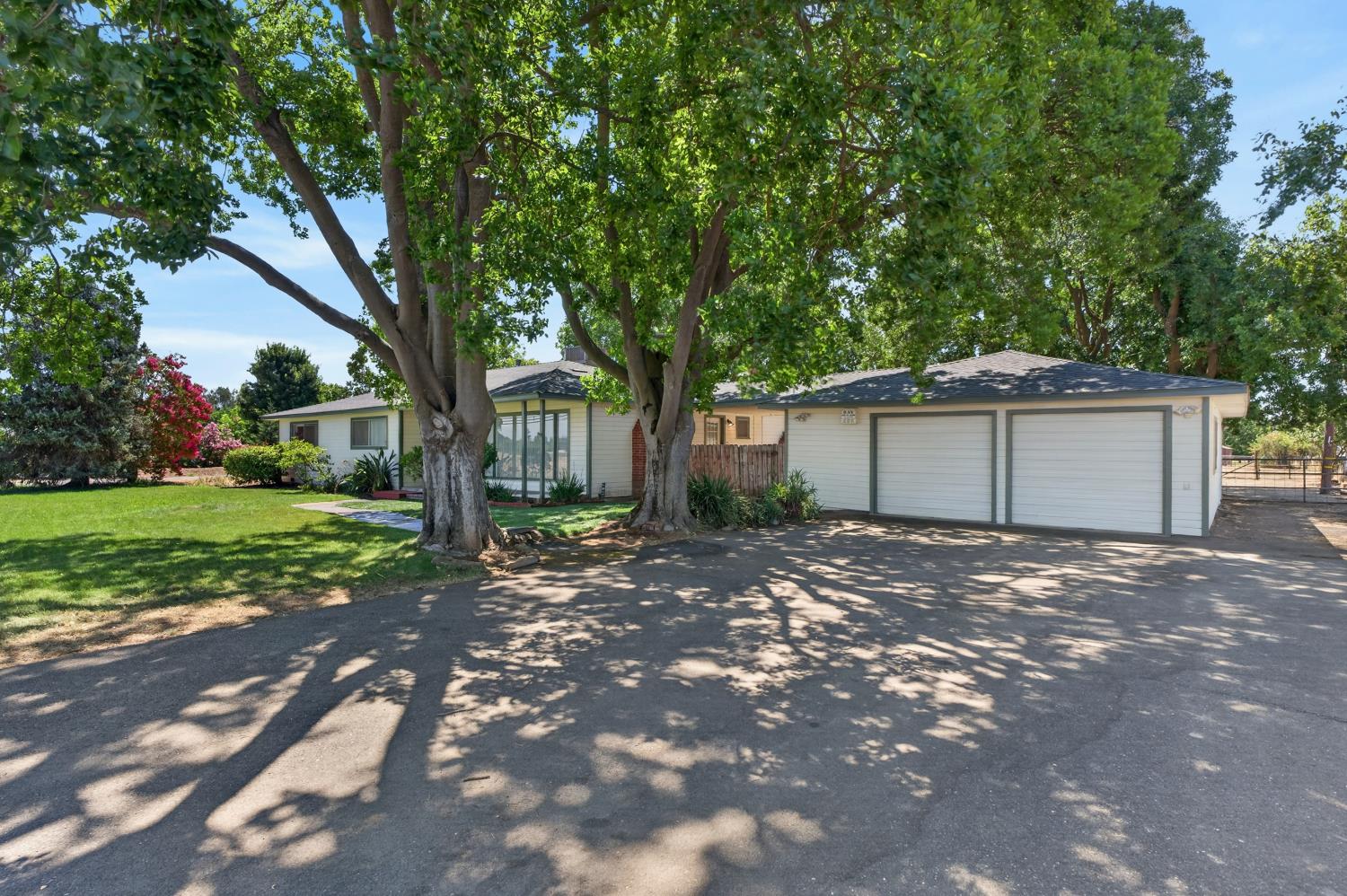 10700 Calvine Road Elk Grove, CA 95830 - Photo 1 of 73 a front view of a house with a garden and trees