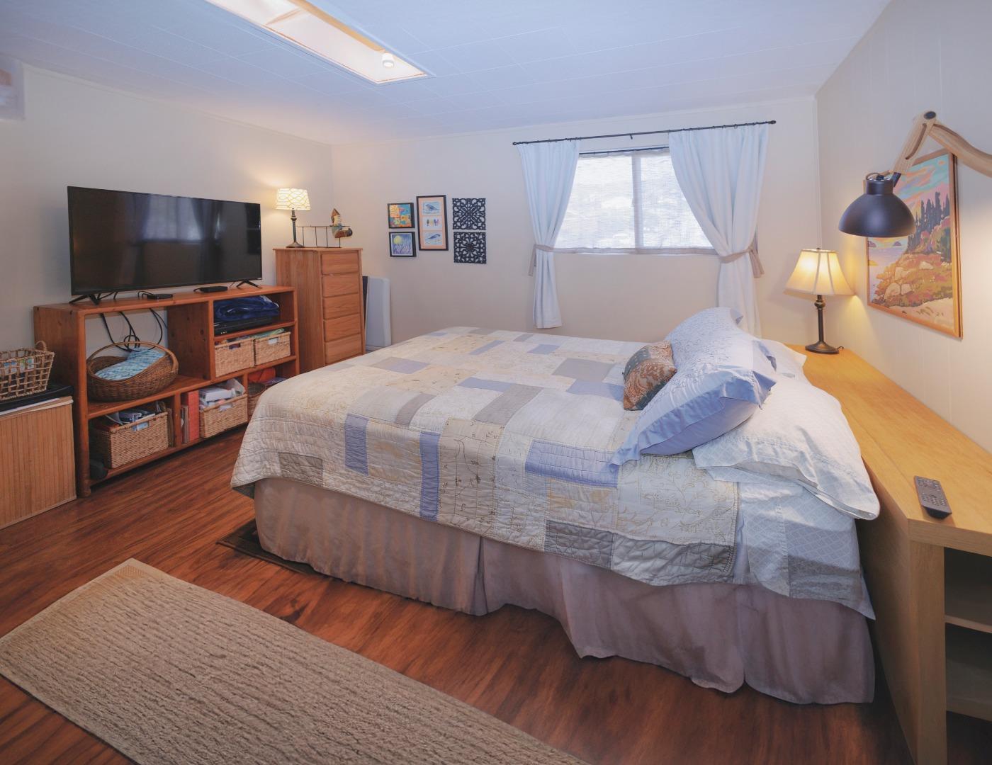 803 Big Bend Drive Pacifica, CA 94044 - Photo 24 of 47 a bedroom with a bed and a flat tv screen on dresser